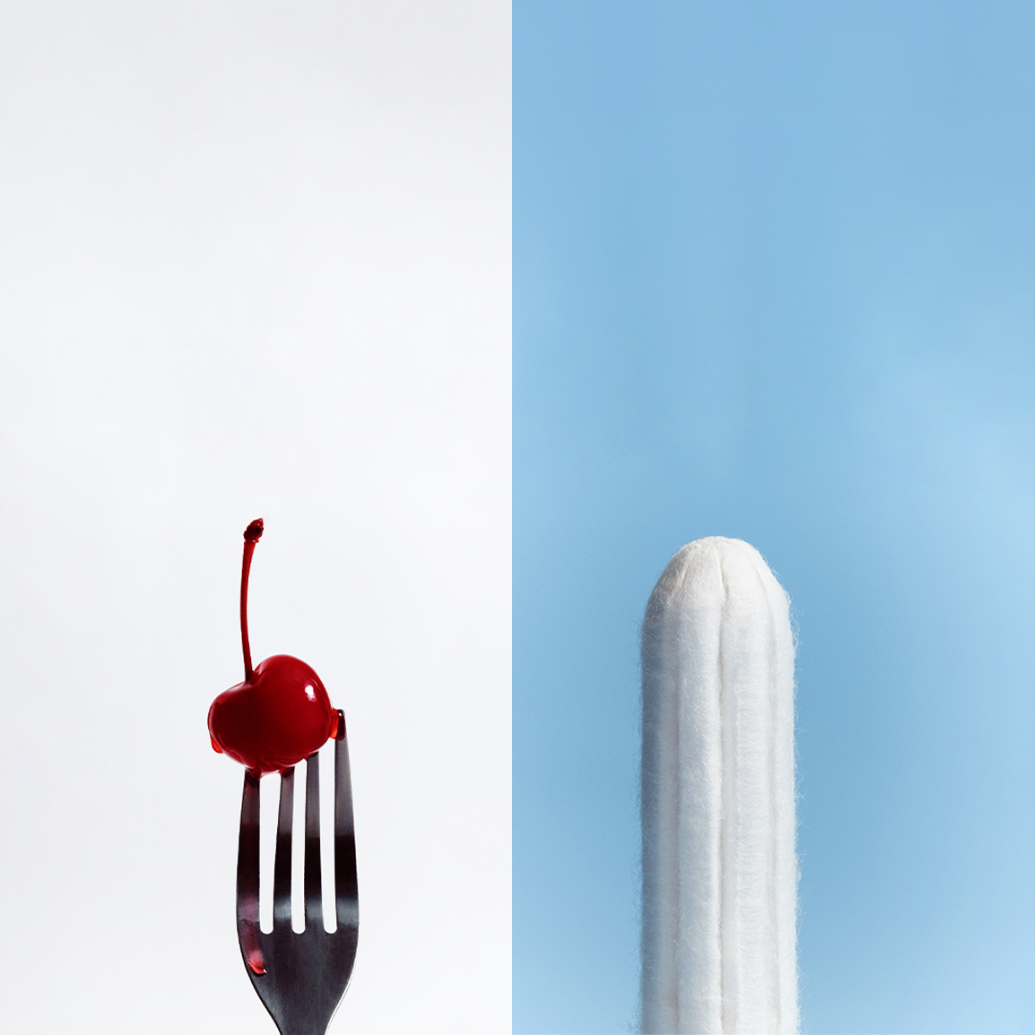 Divided image showing a fork with a cherry on the end on one side and a tampon on the other.