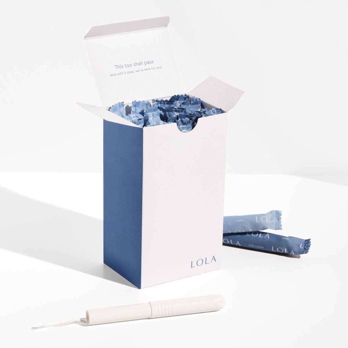 Cardboard applicator tampons | Front view of Cardboard applicator tampons packaging with one unwrapped tampon