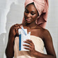 Cardboard applicator tampons | Front view of women in bath towel pulling out a tampon from a box